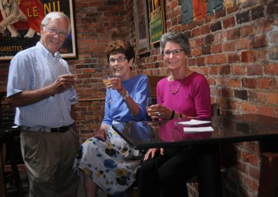 seniors toasting at a bar